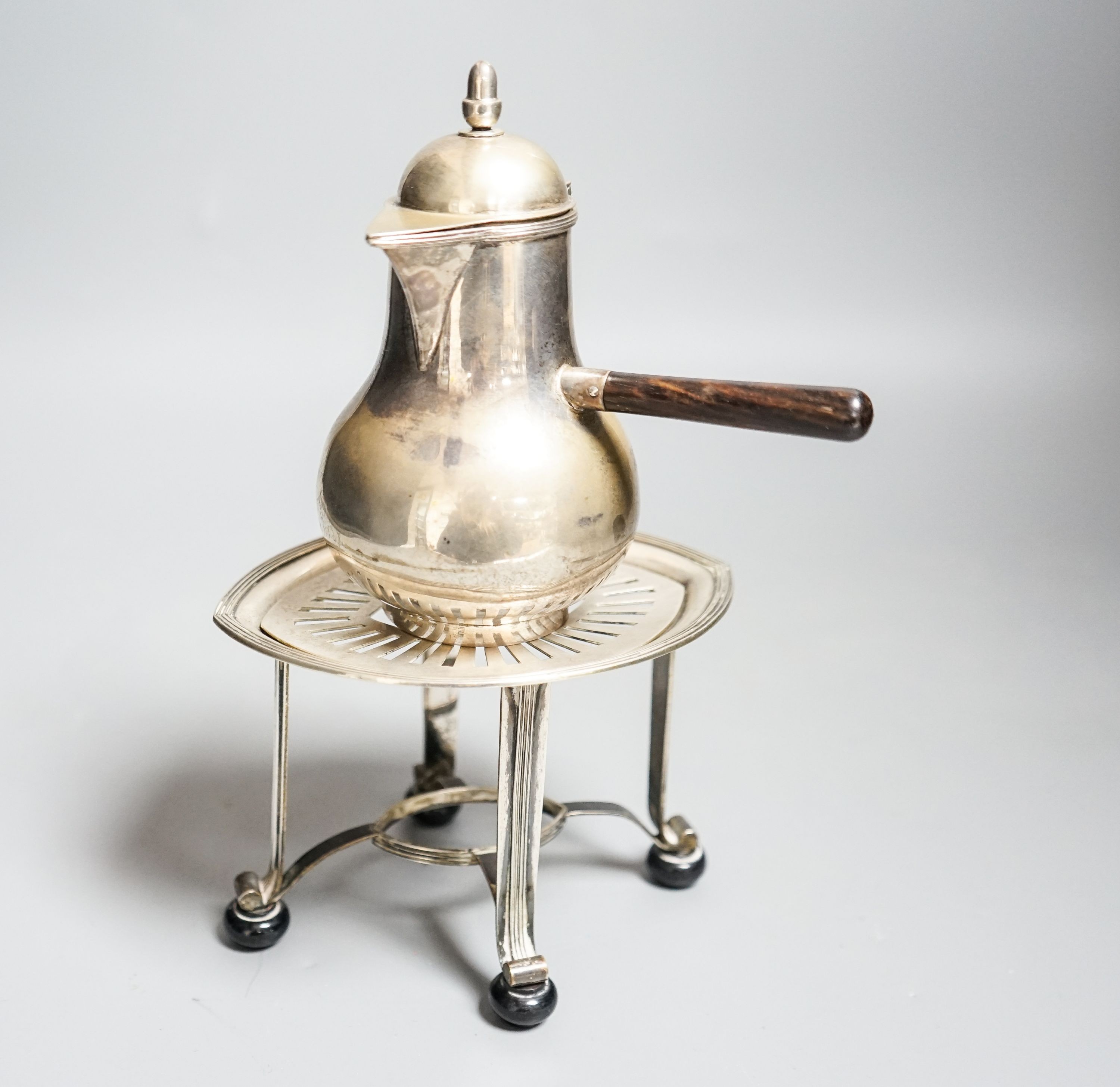 A Dutch white metal cafe-au-lait pot, with hinged cover, acorn finial and wooden handle, height 13cm, together with a Dutch white metal stand, gross 9.5oz.